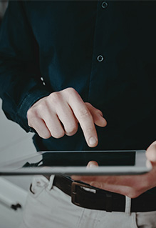 Overhead shot of a person pressing on a tablet